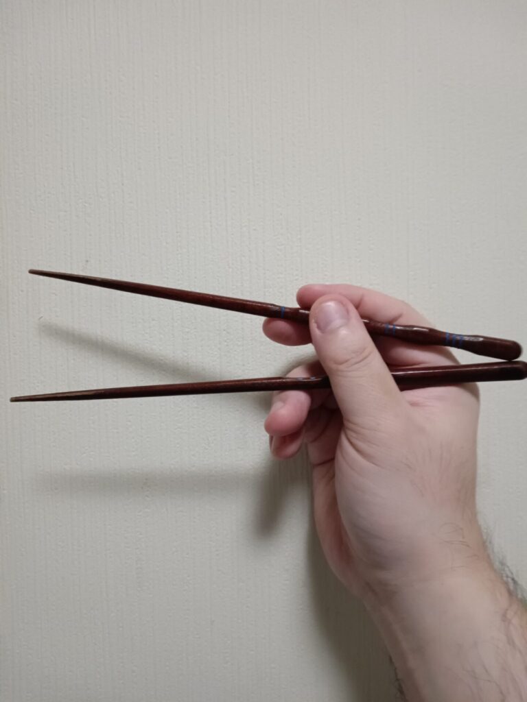 Using chopsticks with both hands