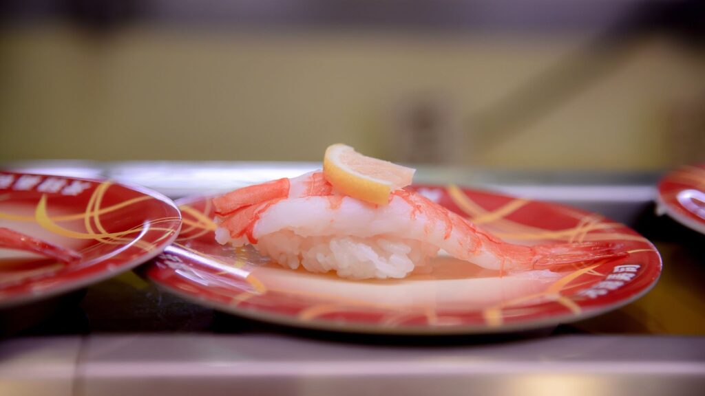 Shrimp on a conveyor belt sushi rail