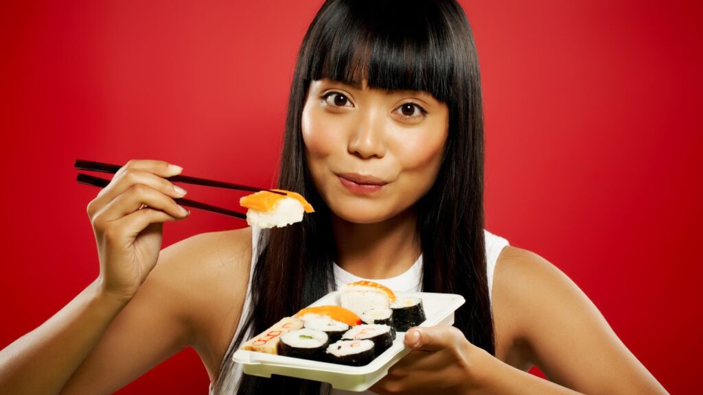 woman eating sushi